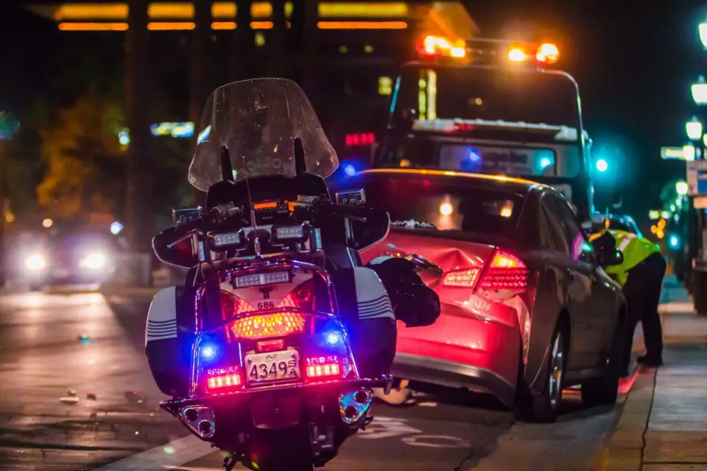Car accident scene with police motorcycle.